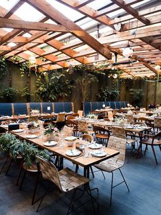 an indoor dining area with wooden tables and chairs