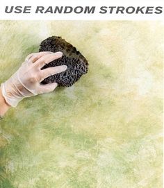 a person in white gloves holding up a black substance with the words use random strokes on it