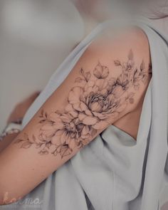 a woman with a flower tattoo on her arm