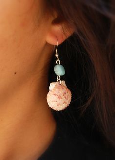 a close up of a person wearing earrings with cupcakes and beads on them