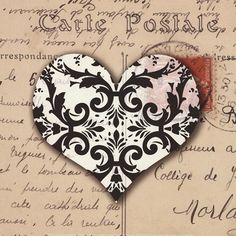 a black and white heart on top of a piece of paper