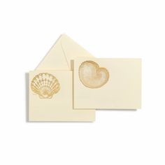 two cards with seashells on them, one is white and the other has gold foil