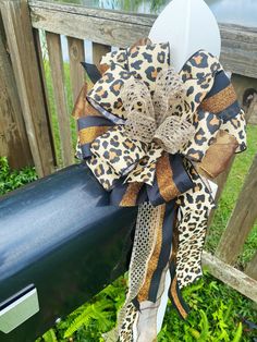 a leopard print bow on top of a mailbox