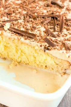 a close up of a cake in a pan with chocolate shavings on top