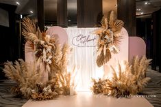 an image of a stage set up with flowers and feathers on the floor for a wedding