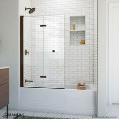 a bathroom with a white tiled wall and floor, including a bathtub in the corner