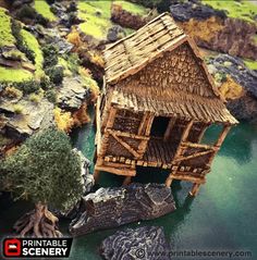 a small wooden house sitting on top of a lush green hillside next to a body of water