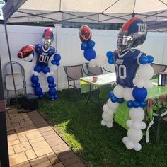 balloons are attached to the back of two football players