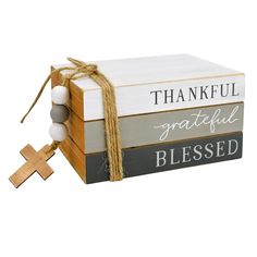 a wooden box with a cross on the front and two different books stacked next to it