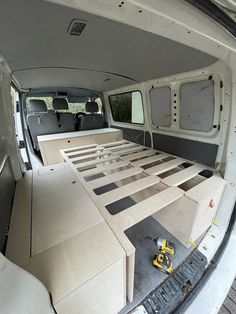 the interior of a van with multiple beds in it