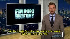 a man standing in front of a tv screen with the words finding bigfoot on it