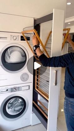 a man standing in front of a washer and dryer