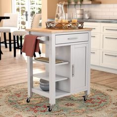 a kitchen island cart with two plates on it in the middle of a living room