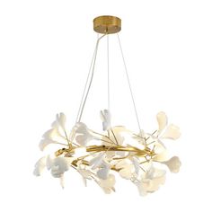 a chandelier with white flowers hanging from it's center and gold accents