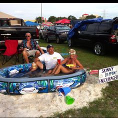 three people sitting in an inflatable swimming pool