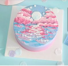 a cake decorated with clouds, stars and the moon