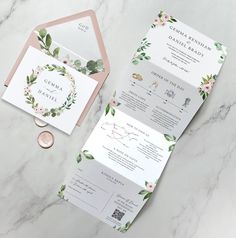 the wedding stationery is set on top of a marble table with coins and paper