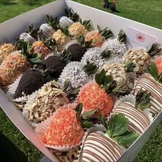 a box filled with lots of different types of chocolate covered strawberries and candy bars