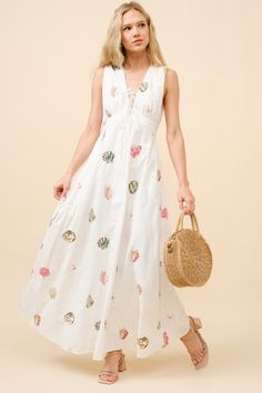 This bestselling style is now back in stock! Nothing says spring and summer like a playful print! Our Lagos Seashell Print Maxi Dress is a classic cotton white dress with an all-over colorful shell embroidery. V neckline and slightly open back with adjustable ties to give you the perfect fit. Smocked waist at the back. This is THE dress of summer. Dress With Seashells, Embroidered Cotton Dresses For Beach Season, Shell Print Dress, Beach Embroidered Mini Cotton Dress, Cotton White Dress, Shell Embroidery, Embroidered Maxi Beach Cover-up Dress, Floral Embroidered Maxi Dress For Beach Cover-up, Seashell Print