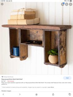 a wooden shelf with two open shelves on it and a blue mug in the middle