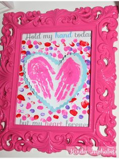 a pink frame with two hands in the shape of a heart and words hold my hand today