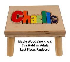 a wooden block with the word charlie spelled in colorful letters on it, sitting on top of a small table