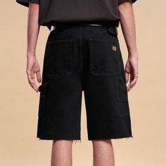 The Frayed Double-Knee Cargo Shorts in Black perfectly merge street style with casual comfort. These slightly oversized five-inch shorts feature a durable double-knee design and frayed hems, adding an edgy touch. The back pocket is adorned with a branded leather logo patch for a distinctive look. Made from premium 100% cotton fabric (12.6 ounce/m²), these shorts ensure both durability and comfort, making them a versatile addition to any urban wardrobe. Double-knee design for added durability Fra Baggy Streetwear Shorts With Multiple Pockets, Baggy Cargo Shorts For Streetwear, Urban Baggy Shorts With Pockets, Casual Streetwear Shorts With Multiple Pockets, Urban Style Summer Cargo Shorts, Baggy Streetwear Shorts With Side Pockets, Casual Streetwear Shorts With Pockets, Urban Relaxed Fit Shorts With Pockets, Cotton Jean Shorts With Built-in Shorts For Streetwear