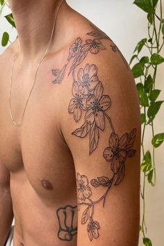 a man with tattoos on his arm and chest