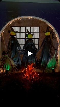 three witches standing in front of a window with christmas lights on it's windowsill