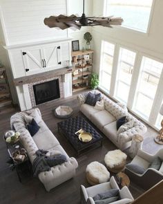 an aerial view of a living room with couches, chairs and fireplace in it