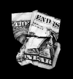 two folded bills sitting on top of each other in black and white, against a dark background