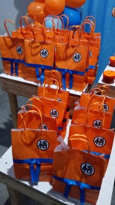 orange bags with blue handles are on display