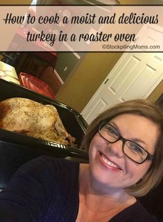 a woman with glasses is smiling in front of a roasting pan full of turkey