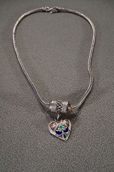 I am offering this very elegant vintage victorian style Sterling Silver fancy bib dangle pendant charm and necklace chain. This necklace features a stations of a combination of oblong and heart shaped multi colored detailed enameled designs, additionally, there is tons of raised relief twisted braided scroll work. This necklace really makes a powerful fashion statement, so lovely! Just look at the detailed etched scrolled filigree framing we have here. You can't help but love the charming design Ornate Pendant Necklaces With Charms, Ornate Pendant Necklace With Charms, Victorian Heart Charm Pendant Necklace, Powerful Fashion, Scroll Work, Vintage Victorian, Bib Necklace, Victorian Style, Star Necklace