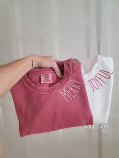 a person holding up a t - shirt with the word mr and mrs on it