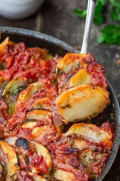 a pan filled with cooked vegetables on top of a table