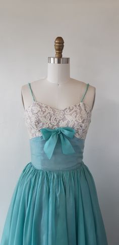 This vintage 1950's pale icy blue lace and chiffon dress is oh so pretty! The dress features a lace bodice with a darted bust, spaghetti straps, a v-neckline, a cinched waist, a soft pleated chiffon skirt with a tulle underskirt and a fit and flare silhouette. A great gift for yourself if you have a love for vintage fashion! ✂------ M E A S U R E M E N T S -------  best fit: x small bust: 32 inches waist: 24 inches hips: free  length: 51 inches tag/label - brand marker: n/a material: lace, chiffon and tulle condition: Very good, As-is. Please review the last photo for flaws; wear, stains and small tears. The dress could be shorten cut off hem stain and straps could be replaced. ★ Packaging, delivery and tracking are included in shipping cost. Express shipping is available! ★ Cleaned prior Blue Party Dresses With Delicate Lace, Vintage Prom Dress With Lace Bodice, Vintage Blue Lace Dress, Tulle Underskirt, Pleated Chiffon Skirt, 1960's Dress, Grad Dresses, Cocktail Party Dress, Chiffon Skirt