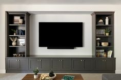 a large flat screen tv mounted to the side of a wall in a living room