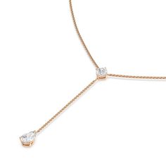 This diamond lariat necklace will easily become your new go-to accessory. It features a Y-shaped chain punctuated by two diamond pendants. Sealing the round loop is a cushion-cut diamond that reflects white and colored light well. A pear-cut diamond sits at the end of the necklace's linear drop. The stylish look of this piece is suitable for both casual and formal wear. Formal Diamond Drop Necklace With Adjustable Chain, Classic Formal Lariat Necklace With Clavicle Chain, Classic Lariat Necklace With Delicate Chain For Formal Occasions, Classic Formal Lariat Necklace With Delicate Chain, Classic Lariat Necklace With Brilliant Cut, Formal Drop Lariat Necklace With Adjustable Chain, Elegant Brilliant Cut Lariat Necklace, Elegant Diamond Necklace With Teardrop Pendant And Adjustable Chain, Classic Lariat Drop Necklace For Anniversary