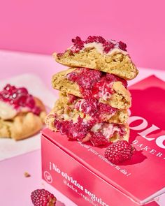 raspberry shortbreads stacked on top of each other in a pink box