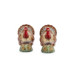 two ceramic turkey figurines sitting side by side