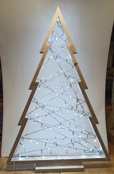 a glass christmas tree with lights on it