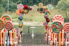 an entrance decorated with lollipops, candy canes and streamers for a wedding