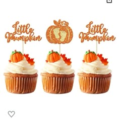 three cupcakes with little pumpkin toppers on them