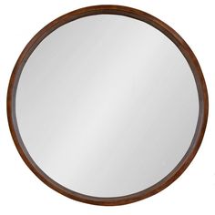 a round mirror sitting on top of a white wall next to a wooden framed object