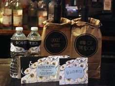 two bottles of water and some cards on a table in front of the bar counter