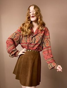 "90s Flowy Button Up Classic bohemian paisley print in red, gold and dark navy blue. Navy buttons down the front. Features a loose fitting collar as well as subtle balloon sleeves. Very lightweight and flowy material. Measurements Shoulders 18\" Bust 48\" Length 26\" Measurements taken with garment laid flat." Vintage Long Sleeve Tops With Boho Print, Bohemian Tops With Vintage Print For Fall, Bohemian Red Tops With Buttons, Red Bohemian Blouse With Paisley Print, Red Long Sleeve Blouse With Paisley Print, Bohemian Blouse With Vintage Print For Fall, Red Bohemian Blouse With Buttons, Fall Vintage Blouse With Vintage Pattern, Vintage Boho Print Top For Fall