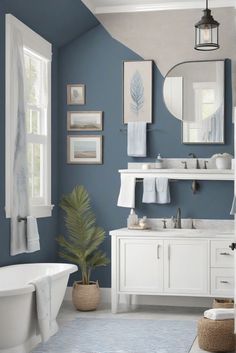 a bathroom with blue walls and white fixtures, including a bathtub in the center