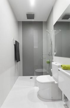 a bathroom with a toilet, sink and shower stall in the middle of it's walls