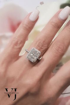 a woman's hand with a diamond ring on it